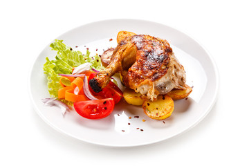 Roast chicken leg with chips on white background