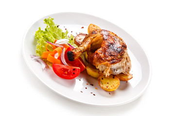 Roast chicken leg with chips on white background