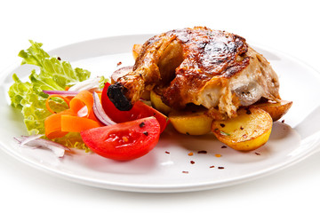 Roast chicken leg with chips on white background