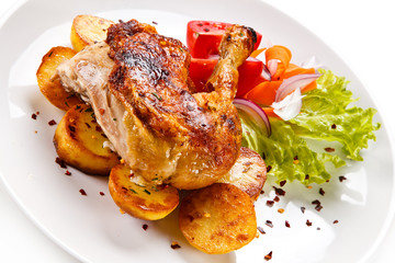 Roast chicken leg with chips on white background