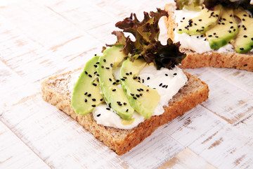 Sandwich with avocado and sesame - healthy breakfast concept
