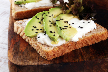 Sandwich with avocado and sesame - healthy breakfast concept