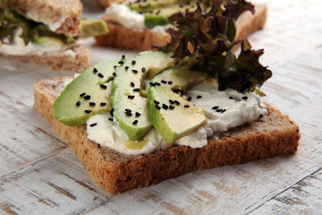 Sandwich with avocado and sesame - healthy breakfast concept