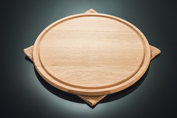 pizza cutting board at black background