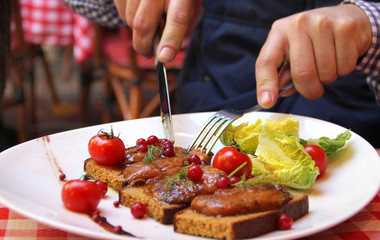 Man eating Foie gras in French restaurant
