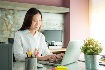 Young asian beautiful woman working with lnotebook computer at home office