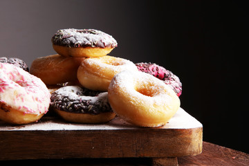 assorted donuts with chocolate frosted, pink glazed and sprinkles donuts.