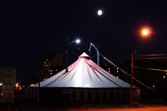 gloomy tent of terrible circus at night in the wasteland.