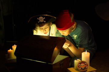 Childhood dreams. Cute girl and adventurous boy found a treasures. Happy young pirates.