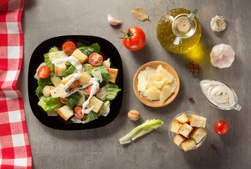 caesar salad and ingredients at table