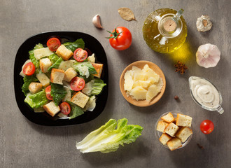 caesar salad and ingredients at table