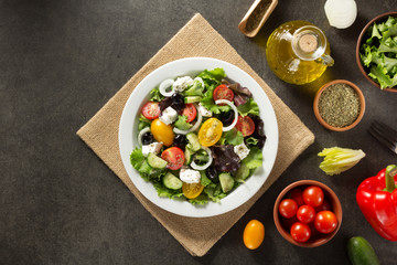 fresh greek salad in plate and ingredients