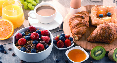 Breakfast served with coffee, juice, croissants and fruits