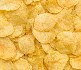 Golden potato chips as food background.