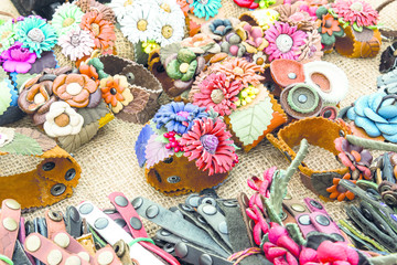 photo leather wristband decorative stylish bracelets with flowers for young people and children lie on the mound on the table