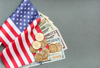 American flag with american money on the grey background.