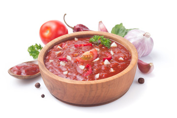 tomato sauce in gravy boat on white