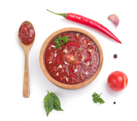 tomato sauce in gravy boat on white