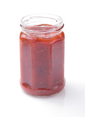 tomato sauce in glass jar on white