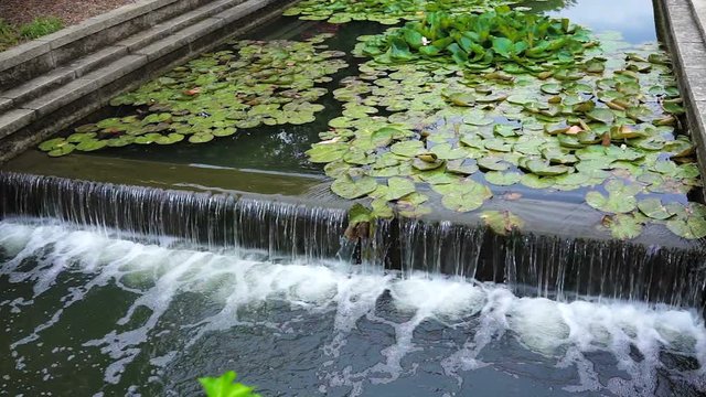 Carroll Creek in Frederick, Maryland city park with canal and fountain waterfall in summer