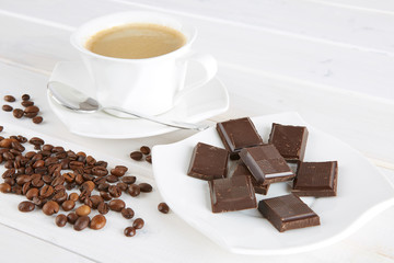 Cup of coffee and a few cups of dark chocolate. 