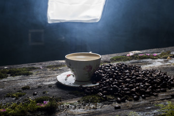 cup of coffee on the background of old tree and leaves