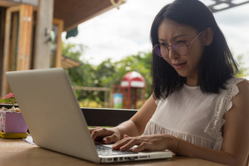 beautiful freelance businesswoman working on her laptop while sitting at the desk