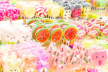 photo background sweets candy on a stick in a display case lined up on sale