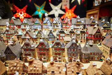 Variety of ceramic houses and star garlands at traditional Christmas market in Strasbourg