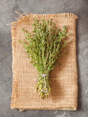 Food background of thyme on black slate board
