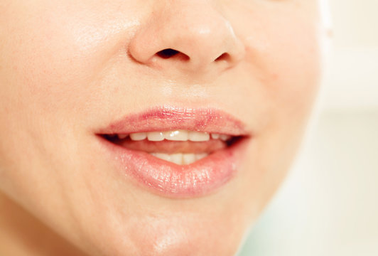Close-up of girl's lips with clean lipstick make up. macro lipgloss make-up