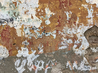 A dirty street wall grey, orange and white. Suitable to be used like a background.
