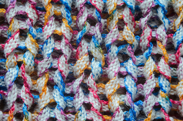 Multi-colored knitted fabric cozy texture background close-up