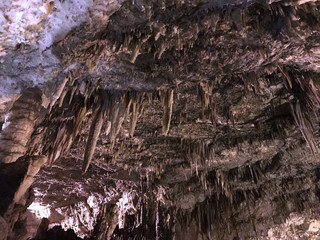 A big cave with stalactites on the rocky ceiling