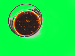 Sour spicy soy with chili black dipping sauce in glass cup, green screen dicut background isolated