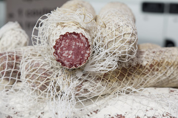 Obraz na płótnie Canvas dried sausage salami in a white packaging