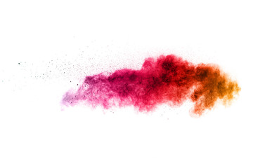 multicolored powder explosion on white background. Freeze motion paint Holi.