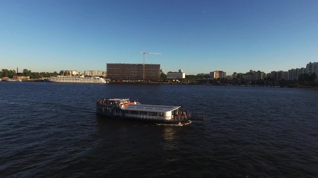 Passenger ship in a city river at the evening