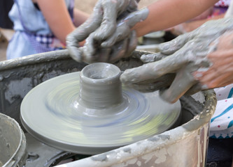 potter making a clay cup