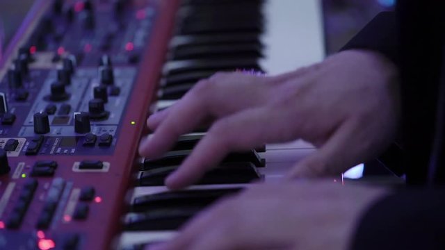 Man playing music on piano keyboard