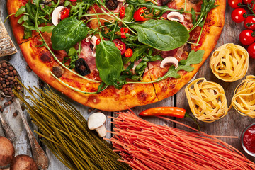 Pizza, spaghetti, vegetables close up.