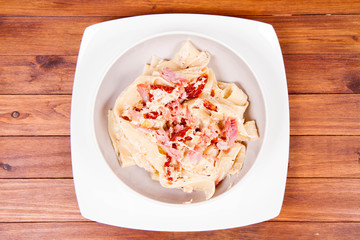 Pappardelle with cream, sun-dried tomatoes and smoked fish