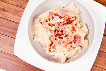Pappardelle with cream, sun-dried tomatoes and smoked fish