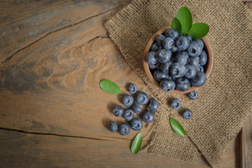 fresh bilberries or blueberries in small wooden bowls
