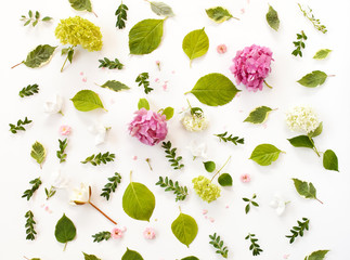 floral pattern made of blooming flowers and leaves. creative arrangement for holiday greeting card. flat lay, top view