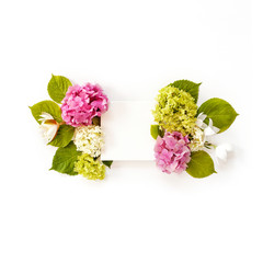 white fabric mock-up with blooming flowers and leaves. flat lay, top view
