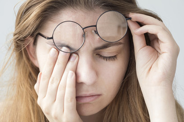 Young woman with eye fatigue