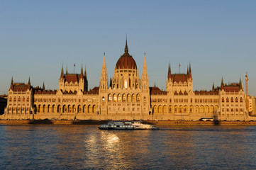 Fototapeta na wymiar Evening view of the illuminated building of the Hungarian Parliament in Budapest.
