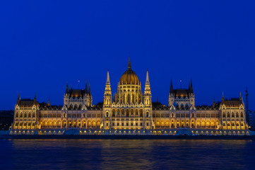 Fototapeta na wymiar Night view of the illuminated building of the Hungarian Parliament in Budapest.