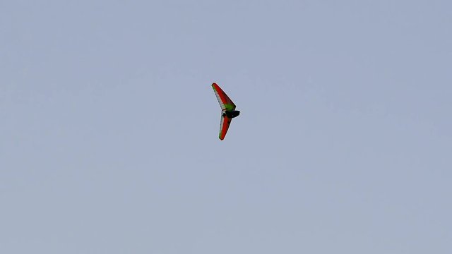 motor paraglider flying in the blue sky. flying hang-glider with a motor on the background